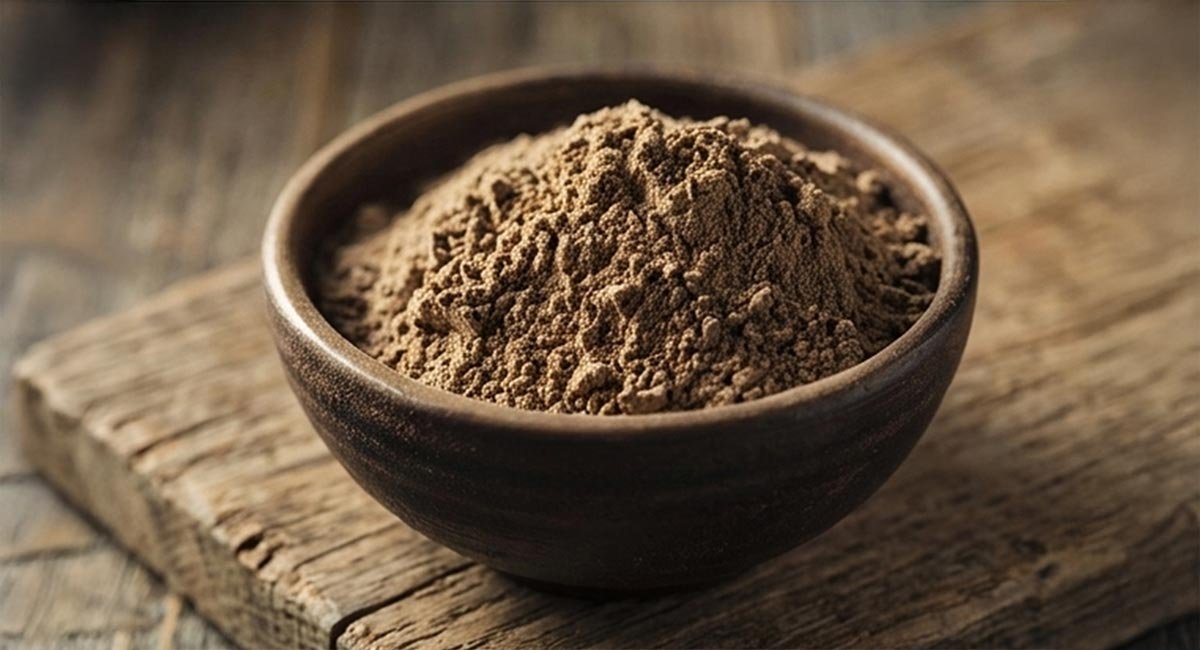 Coarse traditional-grind kava powder in a bowl on a wooden table