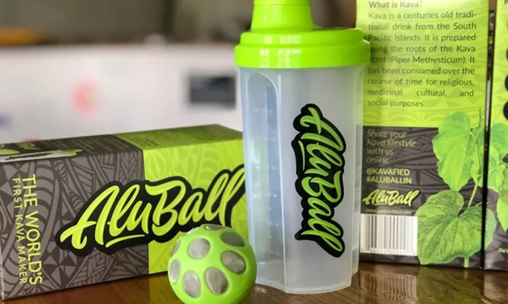 A green AluBall kava shaker with its packaging box