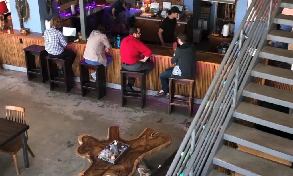 Guests seated at the bar inside Purple Lotus Kava Bar in Miami Beach